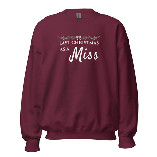 Maroon bridal Christmas jumper with “Last Christmas As A Miss” slogan and festive bow design – perfect for Irish winter brides-to-be.